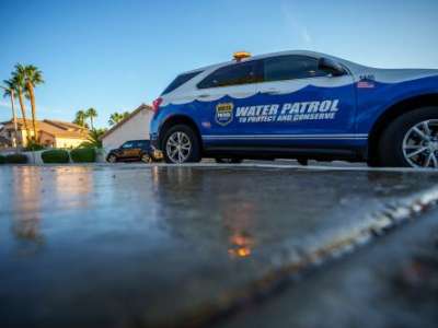 (Trent Nelson | The Salt Lake Tribune) Salvador Polanco-Gamez, a conservation aide with the Las Vegas Valley Water District, patrols in Summerlin, a community in the Las Vegas Valley, Nevada on Thursday, Sept. 29, 2022. When runoff water from a home's sprinklers reaches the street, Polanco-Gamez stops to document the situation and notify the homeowner.