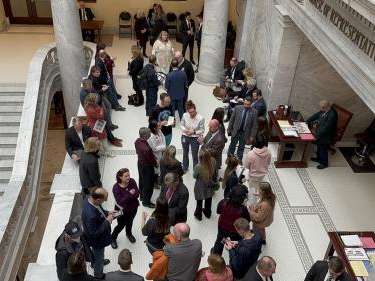 Photo by: Ben Winslow, FOX 13 News  Members of Save Our Great Salt Lake talk to lawmakers outside the House chamber.