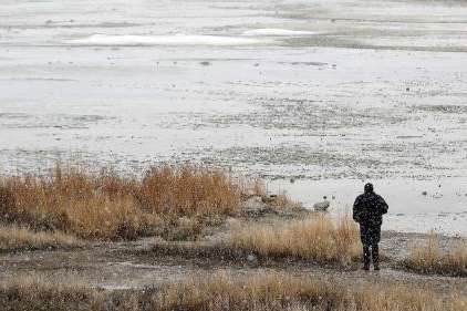 A man looks out over the shoreline at Great Salt Lake State Park in Salt Lake County on Feb. 7. The lake's southern arm is already back to its 2023 peak and could reach 4,195 feet elevation this year for the first time since 2019, experts say. (Kristin Murphy, Deseret News).