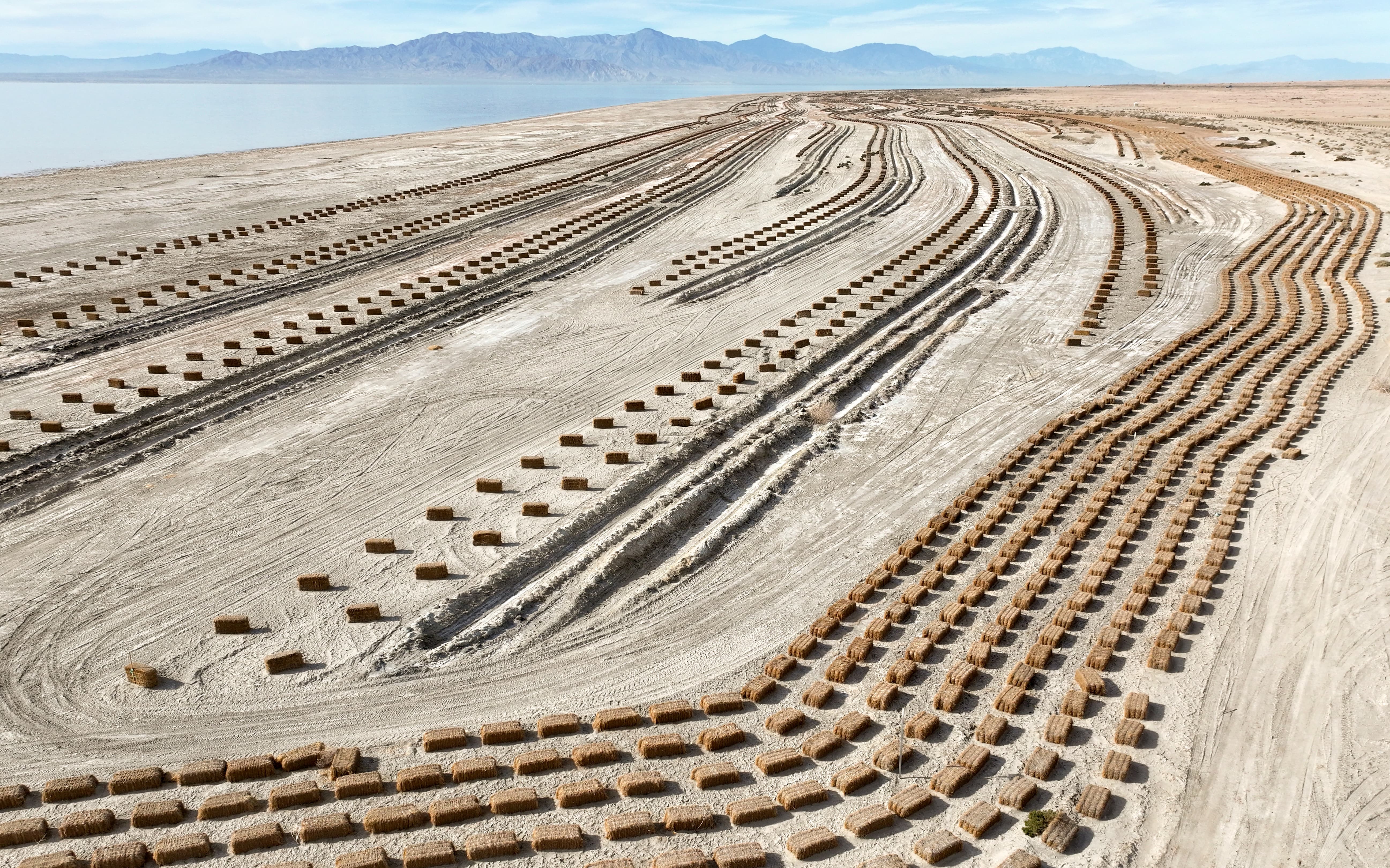 Hay bales used for dust mitigation in a Salton Sea Management Program project are pictured on approximately 68 acres near Bombay Beach, Calif., on Monday, Dec. 11, 2023. Some corresponding seeding to establish vegetation was attempted during last year’s rains, but further planting is on hold until a water source is confirmed.